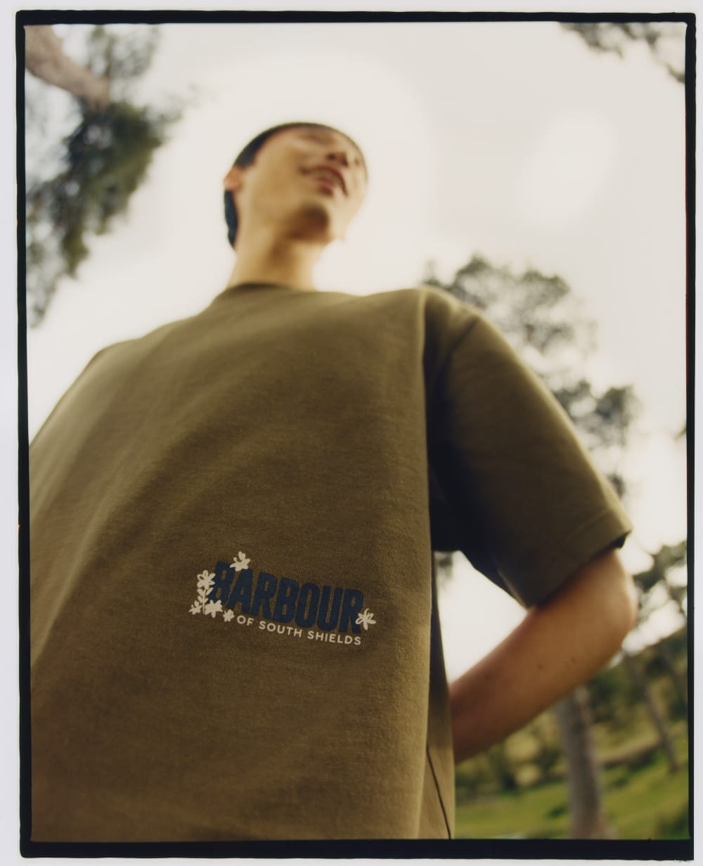 袖のTシャツを着ている男性を下から見た画像